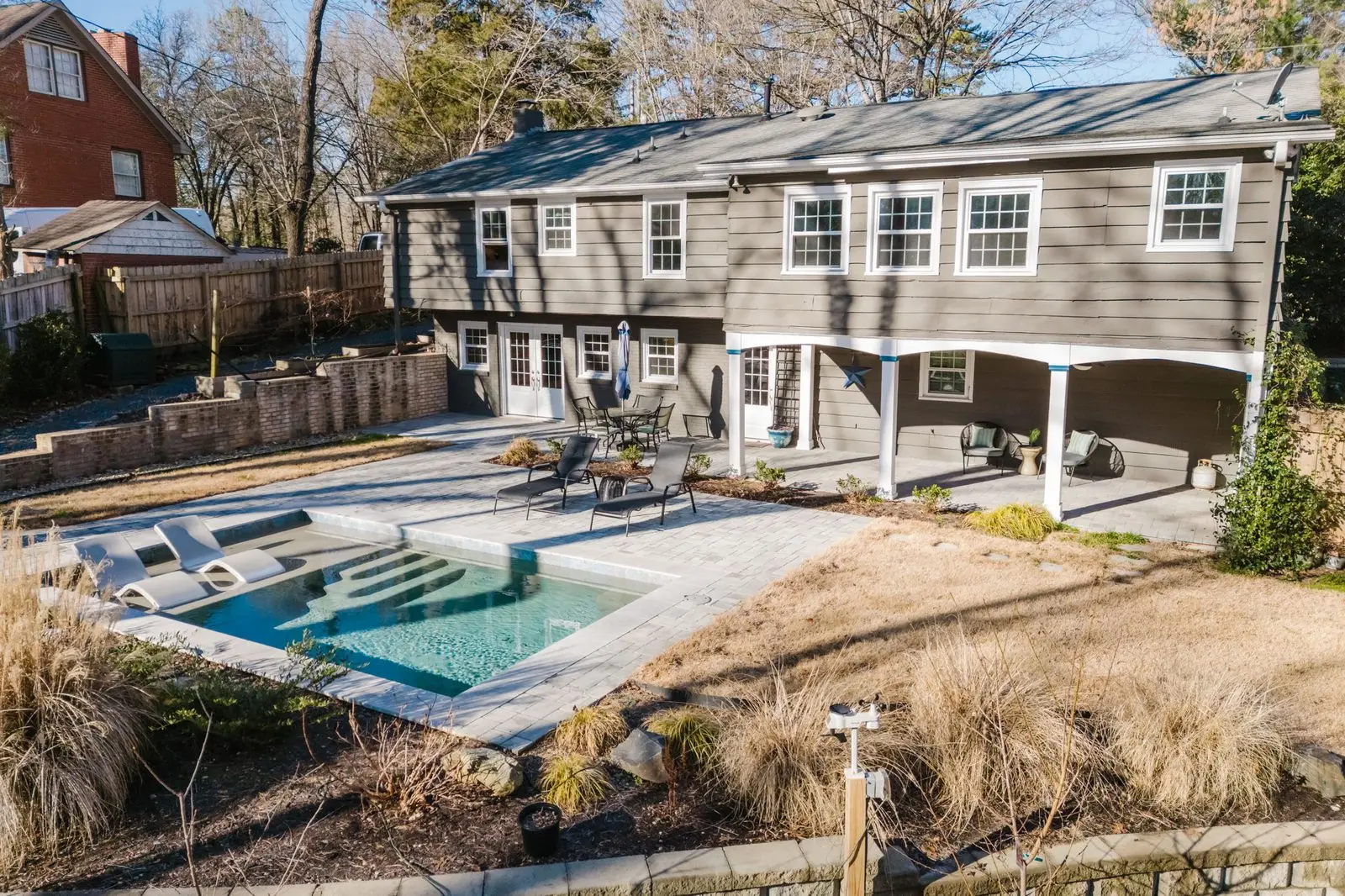 Aerial of 131 Wilby Dr showing brick single-family and mature Sardis Hills tree canopy
