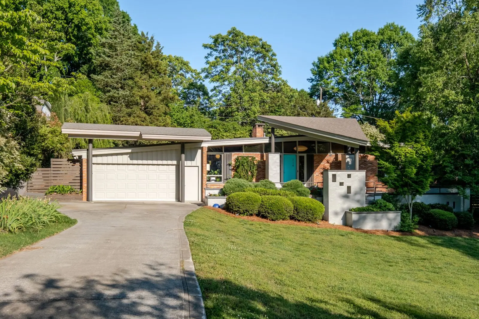 Aerial over 714 Larkhall Ln showing the mid-century roofline and 3/4-acre lot
