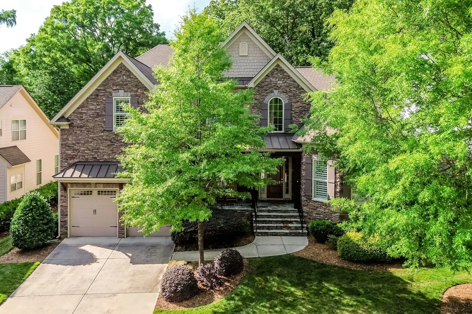 Aerial over 7428 Edenbridge Ln showing gated Bellmore Hall streetscape and mature trees